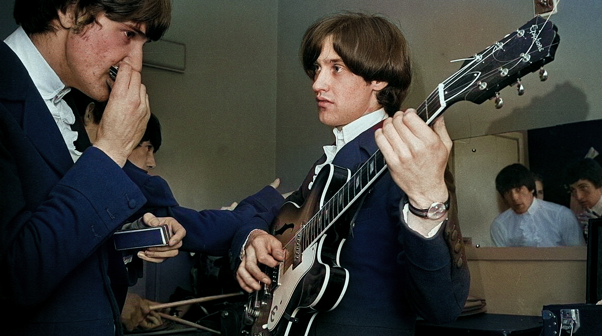 Ray Davies and Dave Davies of The Kinks pop group rehearsing in their dressing room before a concert September1964