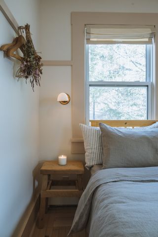 small bedroom with wall light