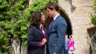 From left to right: Ruby standing and looking at James who is standing right next to her and looking into her eyes.