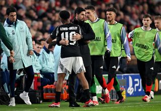 EINDHOVEN, NETHERLANDS - MARCH 04: Myles Lewis-Skelly of Arsenal hugs Mikel Arteta, Manager of Arsenal, as he leaves the pitch due to a substitution during the UEFA Champions League 2024/25 UEFA Champions League 2024/25 Round of 16 first leg match between PSV and Arsenal FC at PSV Stadion on March 04, 2025 in Eindhoven, Netherlands. (Photo by Stuart MacFarlane/Arsenal FC via Getty Images)