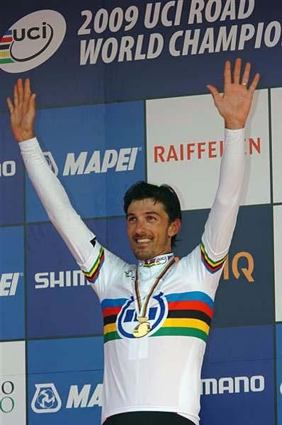 Fabian Cancellara (Switzerland) raises his arms on the podium.