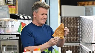 Gordon Ramsay studies a piece of pizza in Kitchen Nightmares