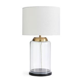 table lamp with glass base and white fabric shade