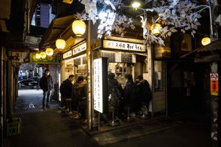 A tiny soba restaurant in Tokyo lit up by lanterns