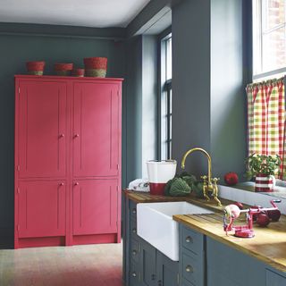 Slate grey kitchen with red pantry unit