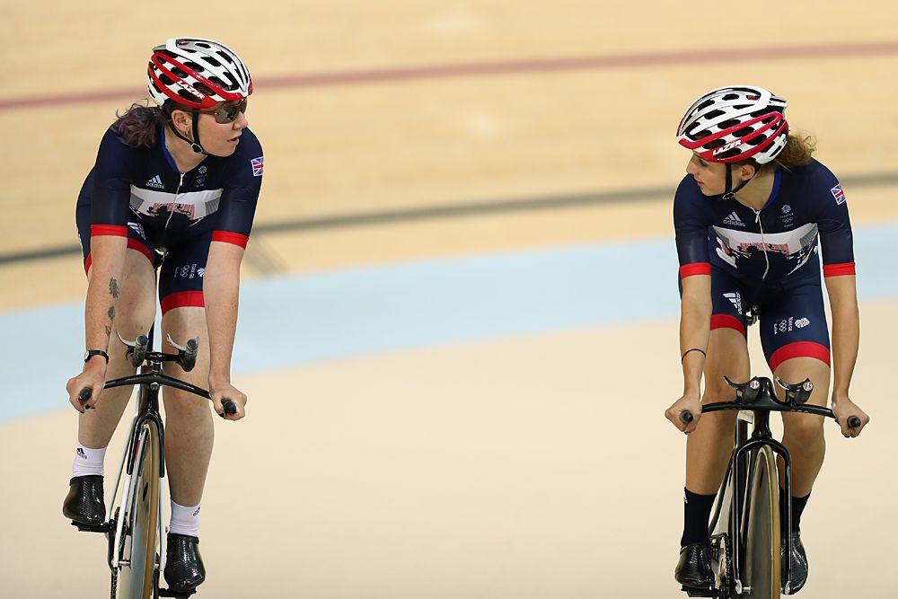 Katie Archibald of Great Britain and Team GB chats to team mate Elinor Barker during training at the Rio Olympic Velodrome