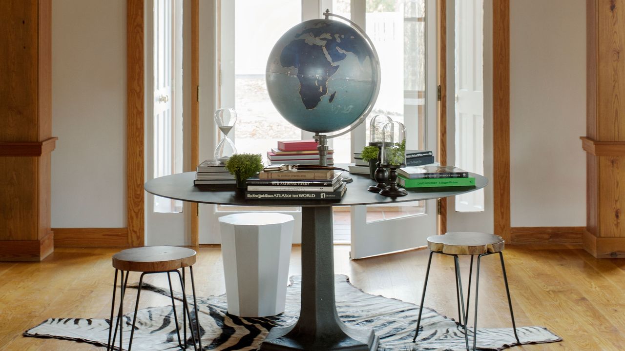 an entryway table with lots of books on top