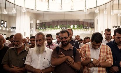Mourners attend the funeral of Ammar Badie, son of the Muslim Brotherhood's Supreme Guide, Mohammed Badie, at the Hammad Mosque in the New Cairo district on August 18, 2013, in Cairo, Egypt.
