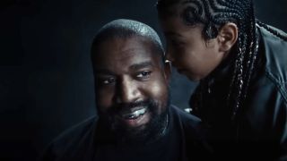 Screenshot of North West singing into Kanye's ear in music video