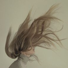 A woman with hair flying over her head