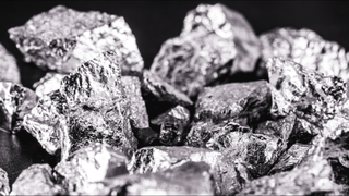 Iridium photographed on a black surface. Iridium is a metallic chemical element belonging to the class of transition metals, silver. Used in high strength alloys that can withstand high temperatures