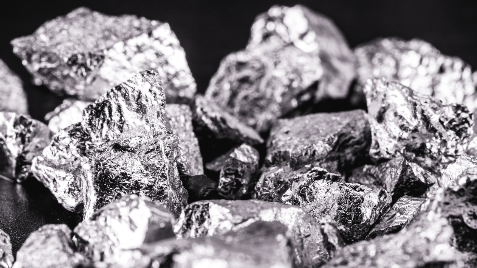 Iridium photographed on a black surface. Iridium is a metallic chemical element belonging to the class of transition metals, silver. Used in high strength alloys that can withstand high temperatures