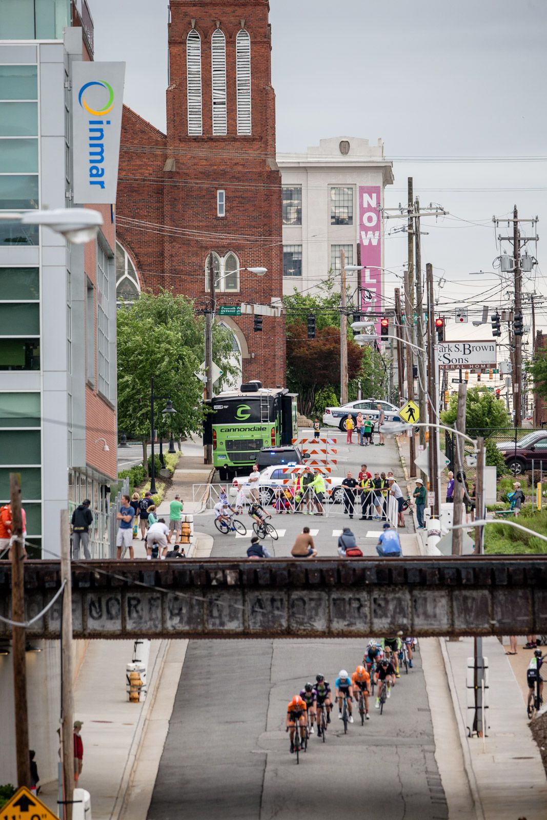 Fans watch from a bridge as the race passes by.