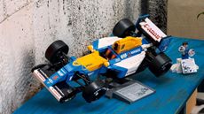 Lego Icons Williams Racing FW14B set on a cabinet near a stone wall