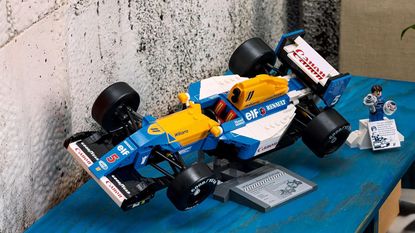 Lego Icons Williams Racing FW14B set on a cabinet near a stone wall