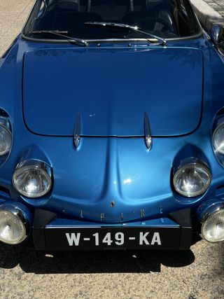 A blue vintage 1970s Alpine car.