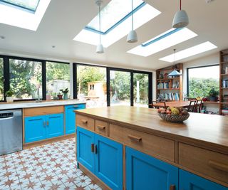 kitchen with wooden units featuring a band of blue paint