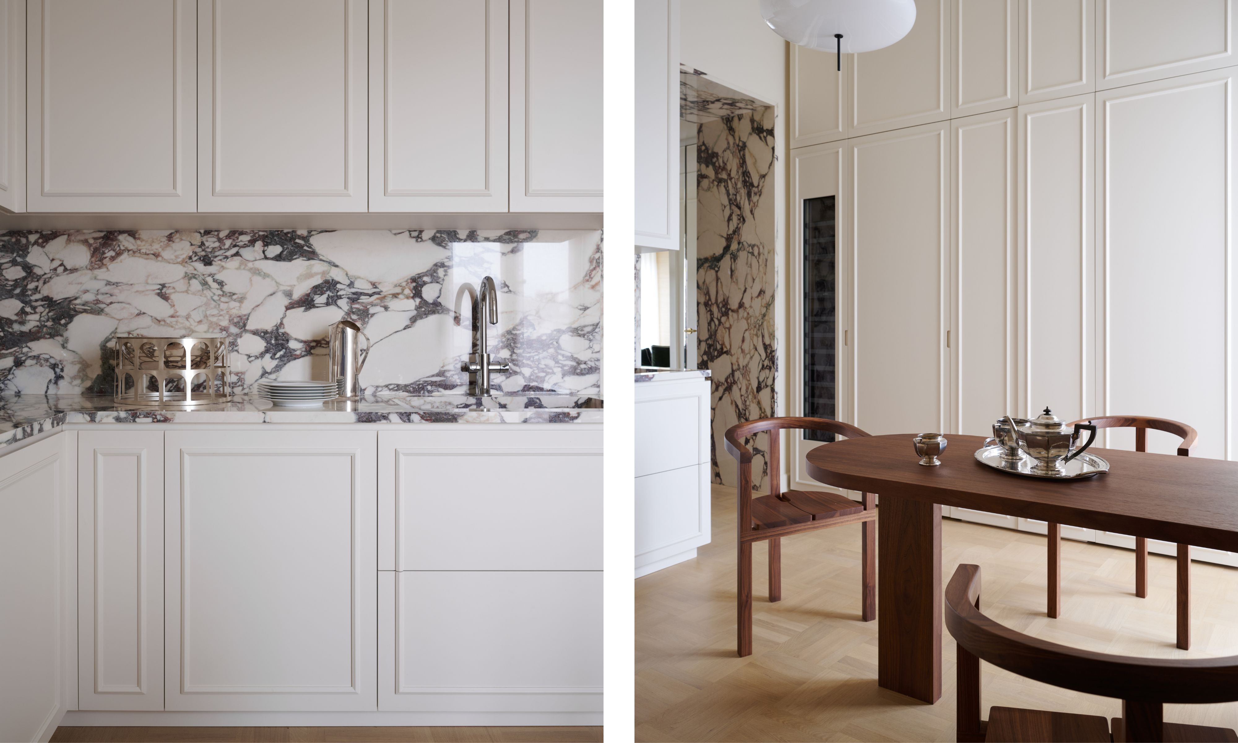a white flat front kitchen with molding detail and a large marble panel