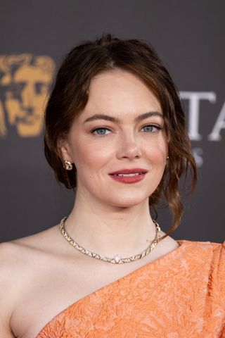 Emma Stone with her hair up in a romantic updo.
