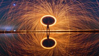 A performer on the mirrored beach at Mitoyo, Japan