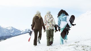 Three skiers walking together