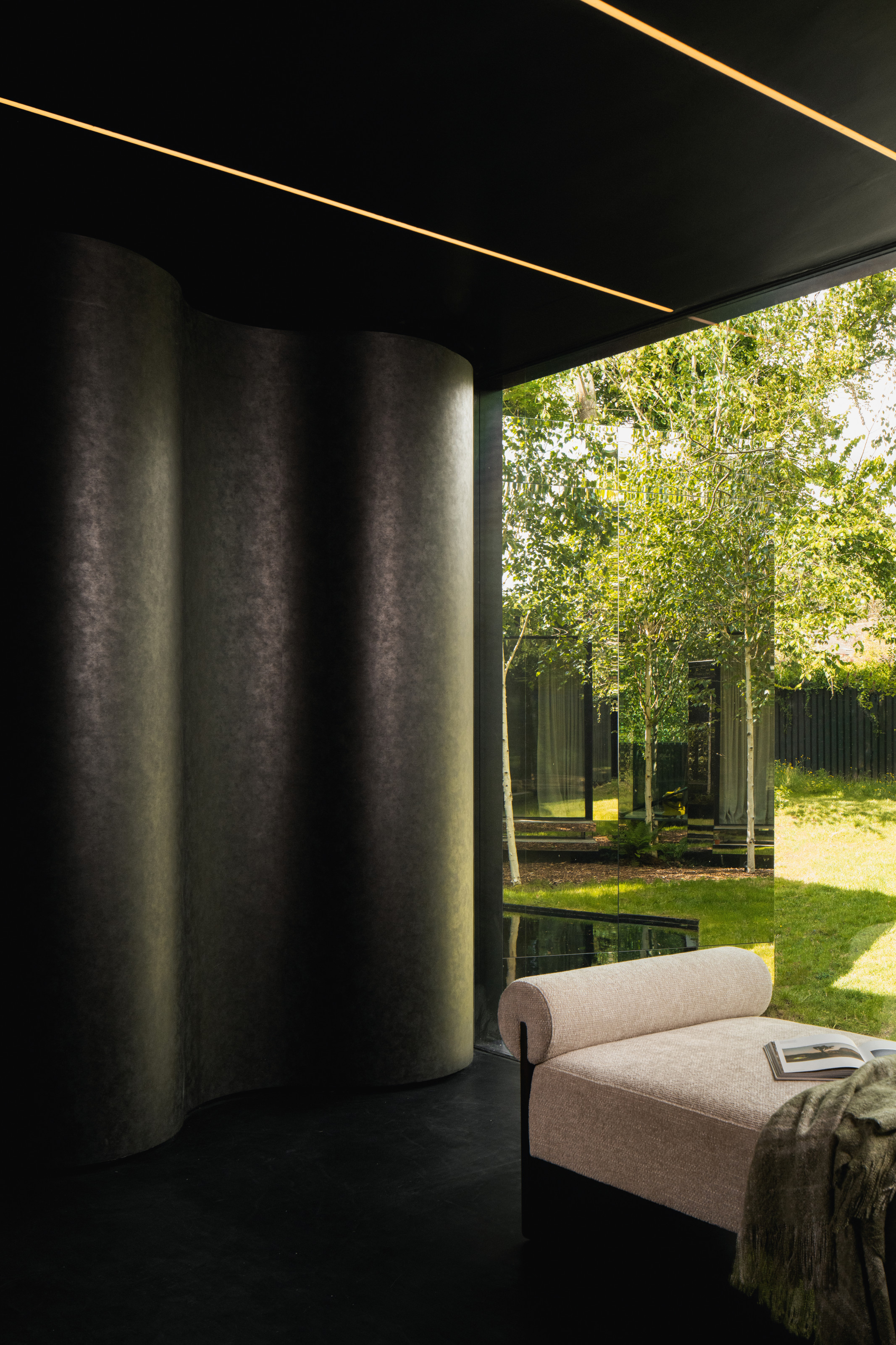 Entrance with hand-drawn curved cabinets in oxidised bronze vinyl