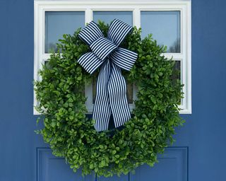 boxwood wreath with blue ribbon