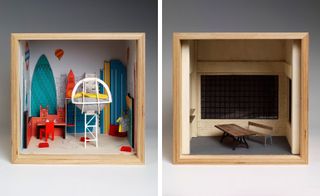 Two side-by-side photos of artistic interpretations of a dolls’ house in square, wooden boxes by several London-based design studios. The first box features a light coloured floor and walls, red and white furniture, a wall-mounted clothing rail with clothes, small red buses and images of air balloons, Big Ben, The Gherkin skyscraper and a London Underground sign on the walls. And the second box features a wooden table, a bench, shelving, brick walls, grey floors and a large black grid style window
