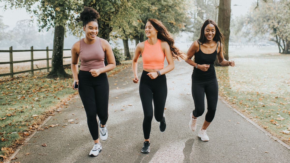 Three women running in park