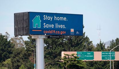 An electronic sign urging Californians to stay at home.