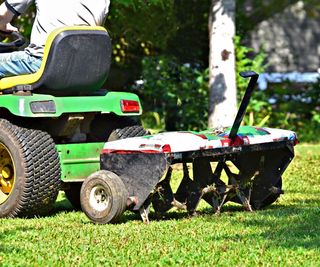 Tow-behind lawn aerator