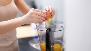 Cracking eggs into a blender