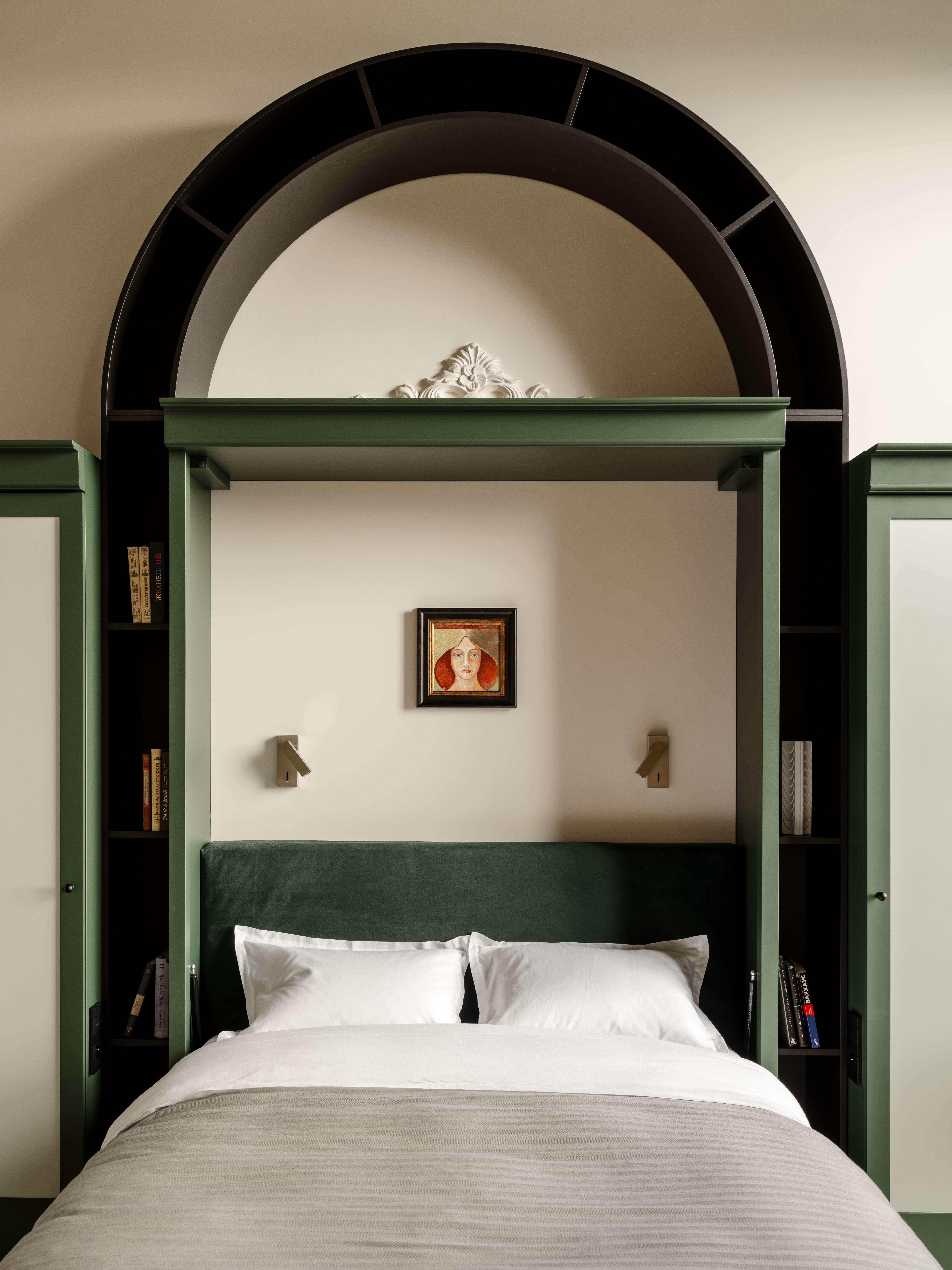 A bed with a green archway around it