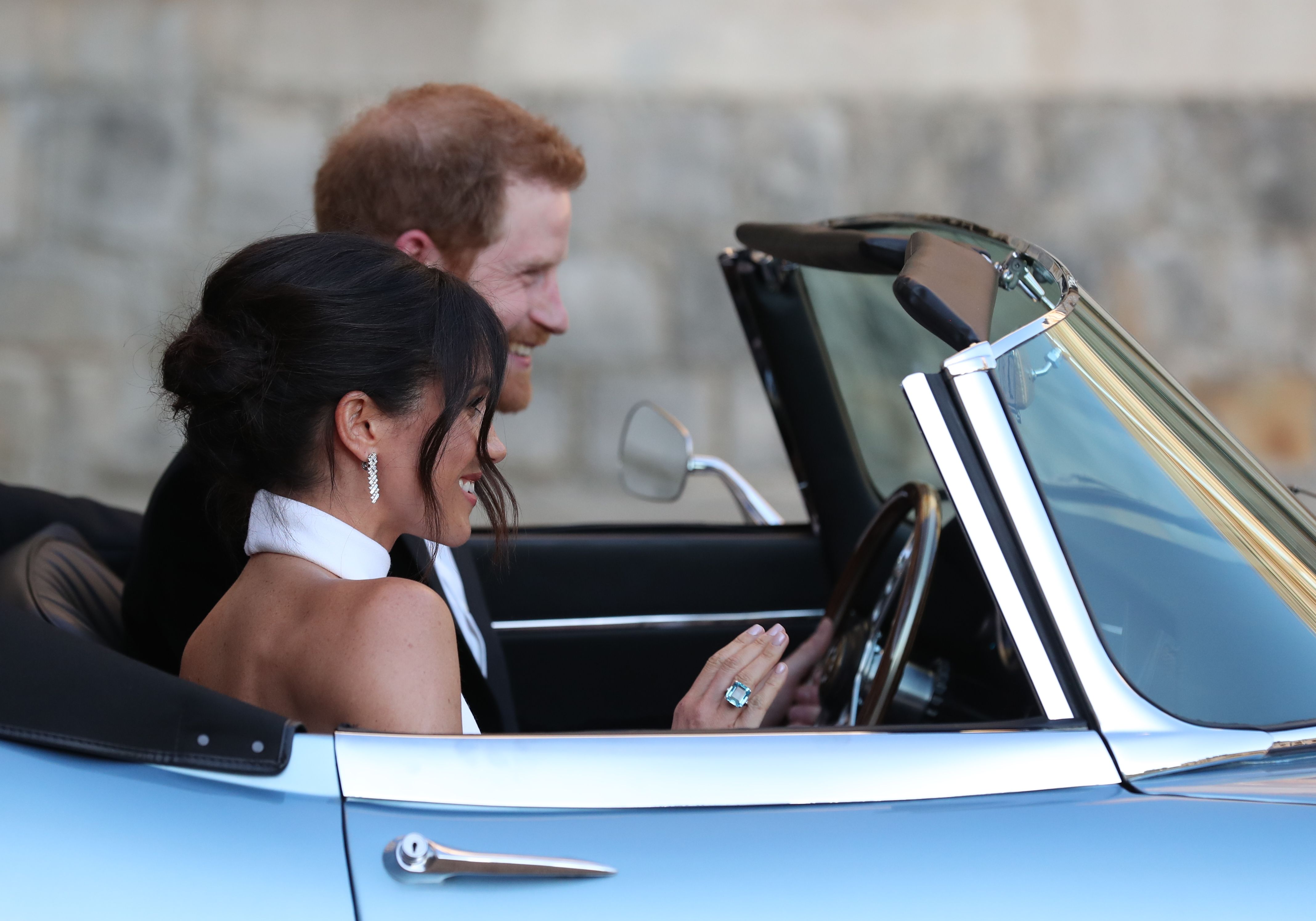 Meghan and Harry driving in a convertible on their wedding day