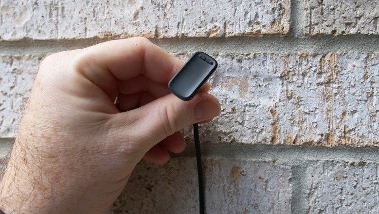 Fitbit Luxe charger held in a hand