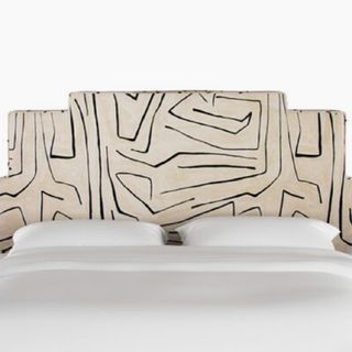 A patterned upholstered headboard