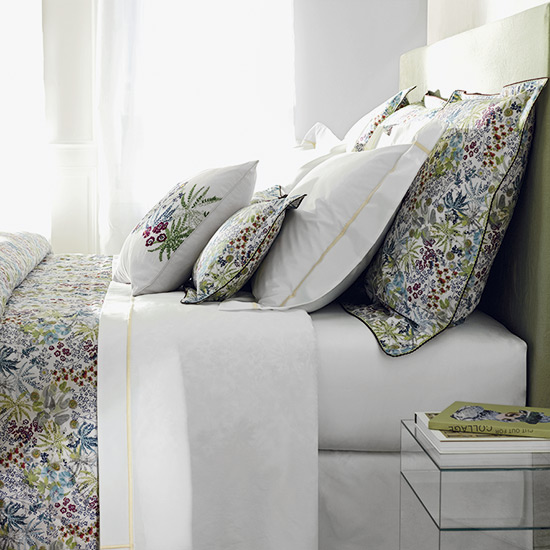 bedroom with glass table and floral printed bedding set