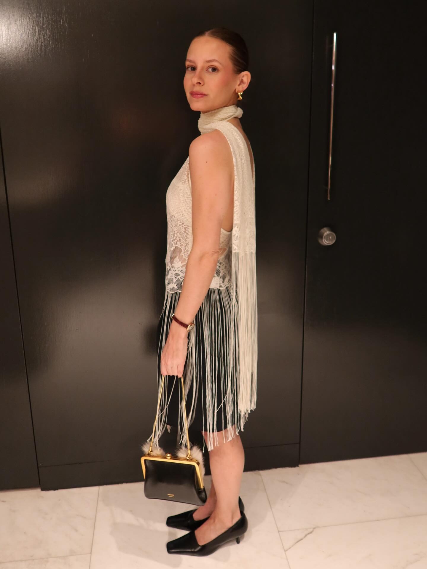 Who What Wear associate fashion editor Nikki Chwatt wears white fringe scarf top and black pencil skirt.