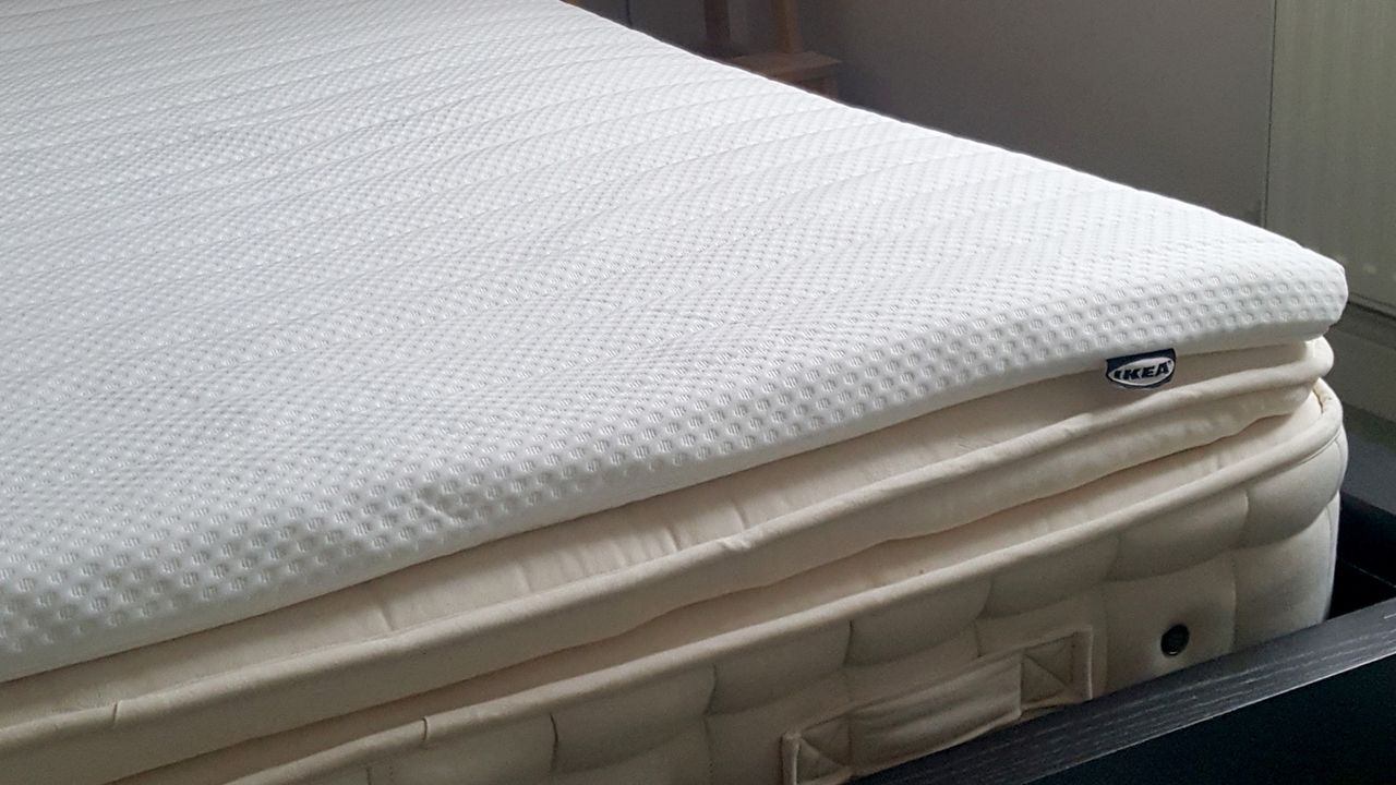 The IKEA NISSEHOLM mattress topper on a bed