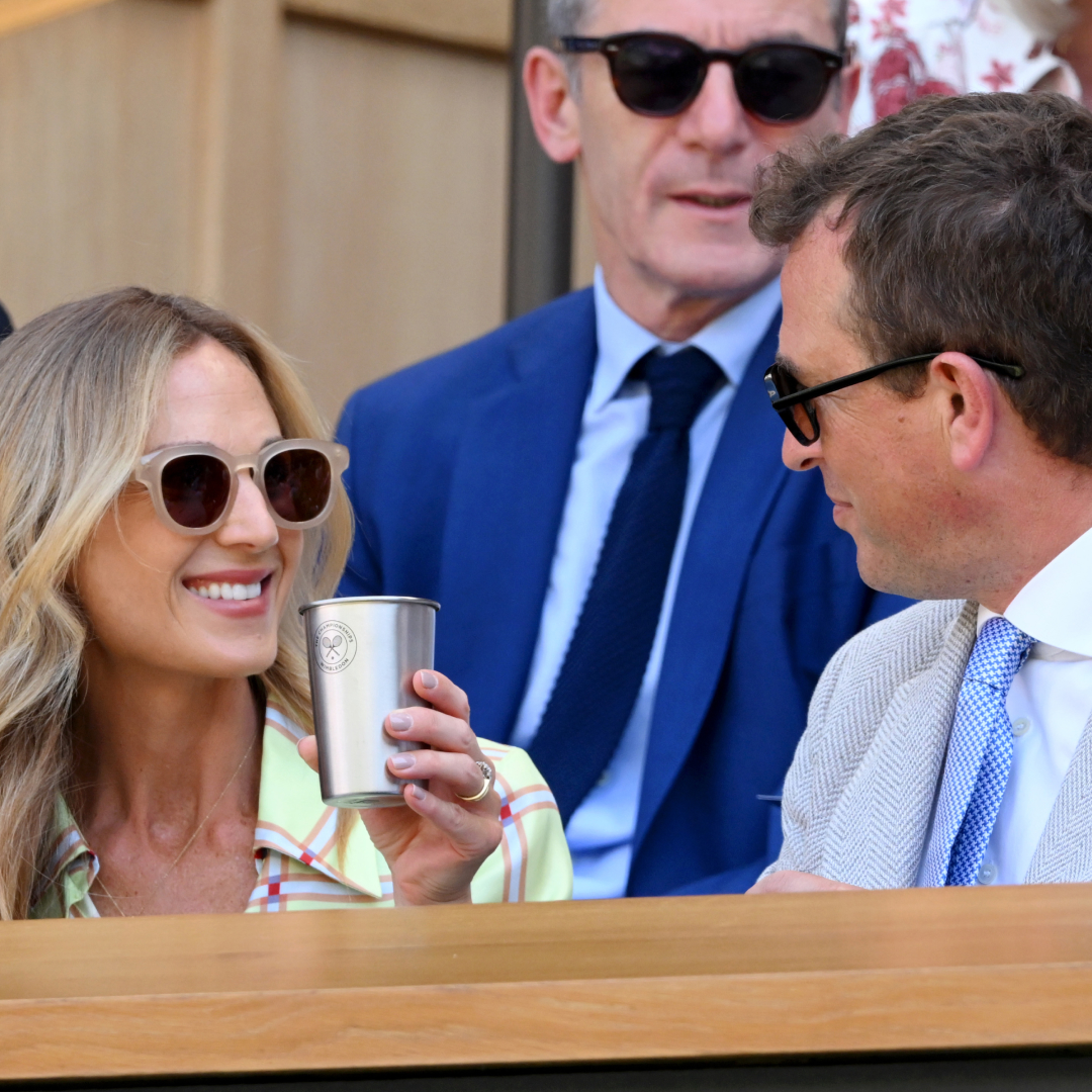Harriet Sperling holding a cup and smiling at Peter Phillips at Wimbledon