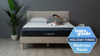 Helix Midnight Luxe image shows Tom's Guide's sleep editor sleeps on her side on the Helix Midnight Luxe mattress, with a blue Holiday sales badge overlaid on the image