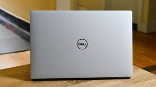 The Dell XPS 13 (2020) showcasing its lid on a coffee table
