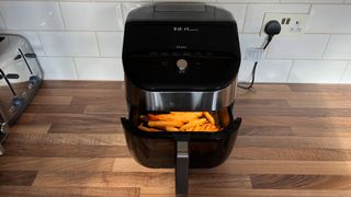 The Instant Vortex Plus 6-in-1 air fryer with ClearCook and OdourEase with fries in the frying basket