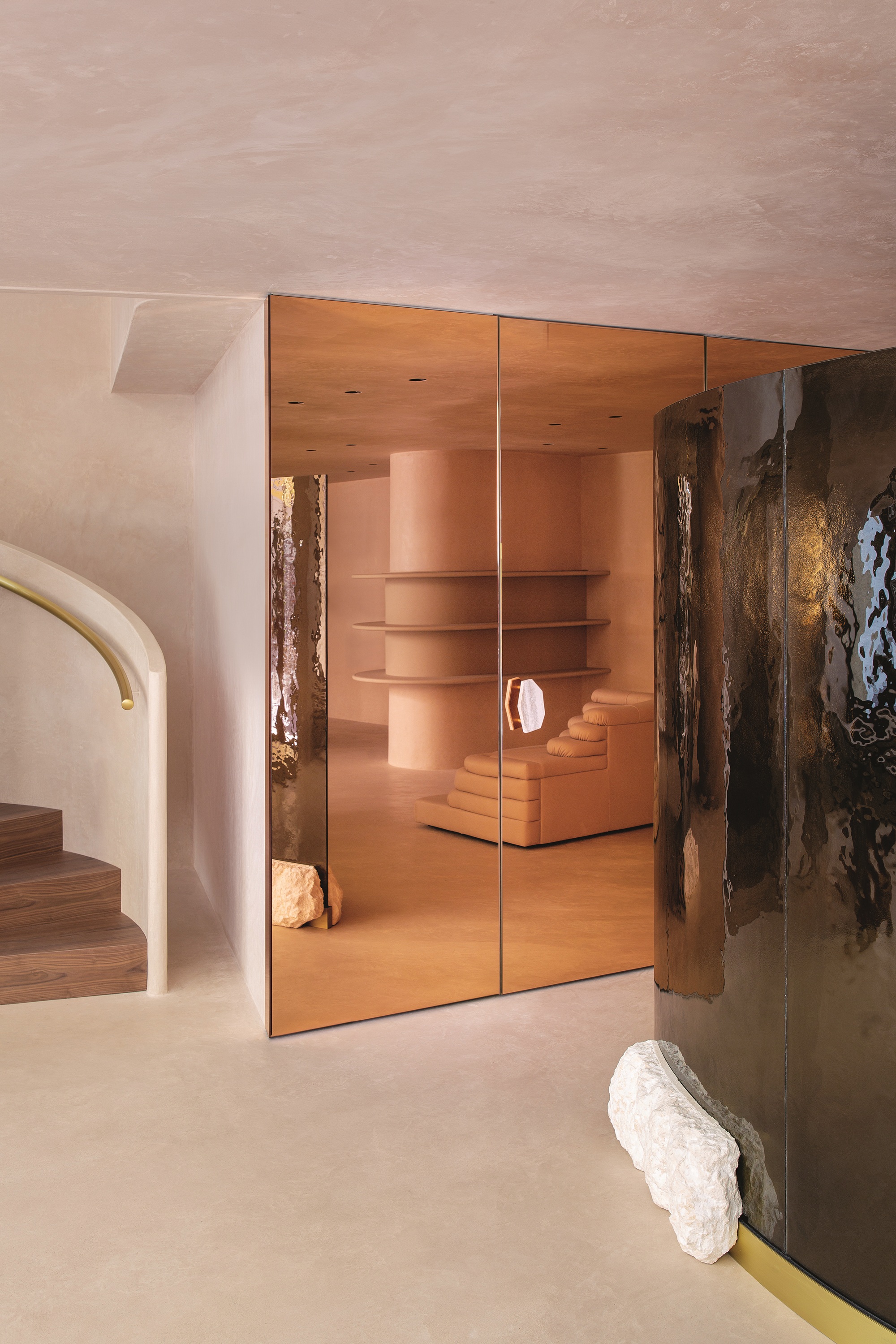 a room with reflective copper colored glass