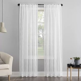 A sheer curtain for the bed