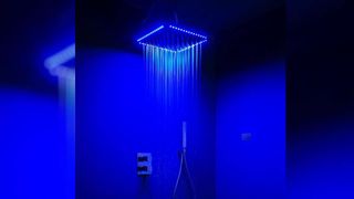 A TenderRain chromatherapy showerhead glows up so you can shower yourself in fairy grotto ambience