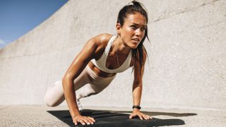 a photo of a woman doing a bear crawl exercise