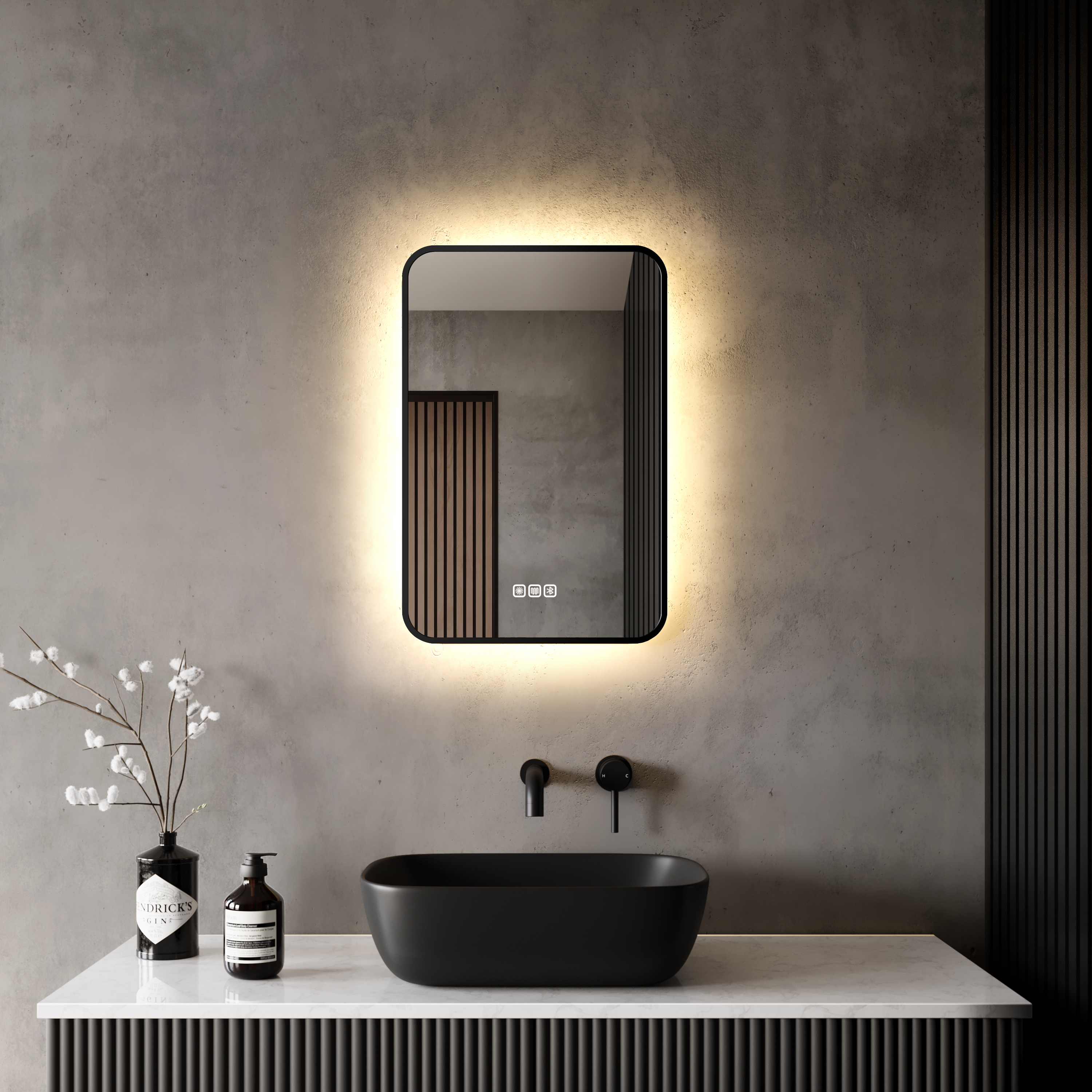 A bathroom with a limewash wall, a black sink and a mirror that&#039;s backlit