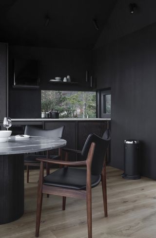 kitchen and dining area in snøhetta designed cabin with Vipp interiors in norway