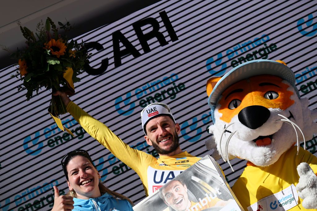 CARI SWITZERLAND JUNE 13 Adam Yates of The United Kingdom and UAE Team Emirates celebrates at podium as Yellow leader jersey winner during the 87th Tour de Suisse 2024 Stage 5 a 1486km stage from Ambri to Cari 1636m UCIWT on June 13 2024 in Cari Switzerland Photo by Tim de WaeleGetty Images